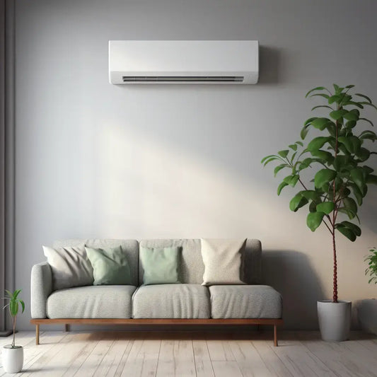 Wall-mounted air conditioner above a modern grey sofa and green indoor plants in a stylish living room.